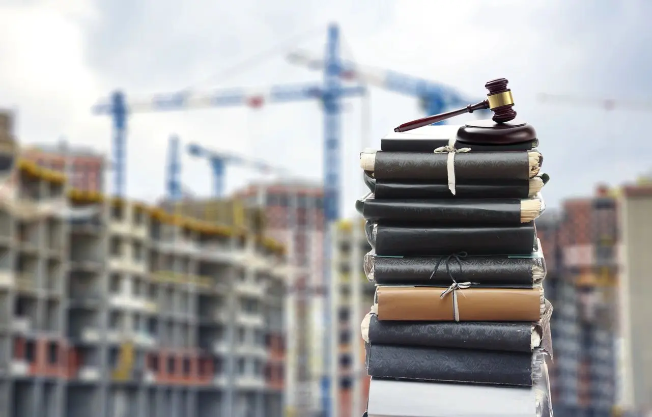 A stack of books with a judge 's gavel on top.