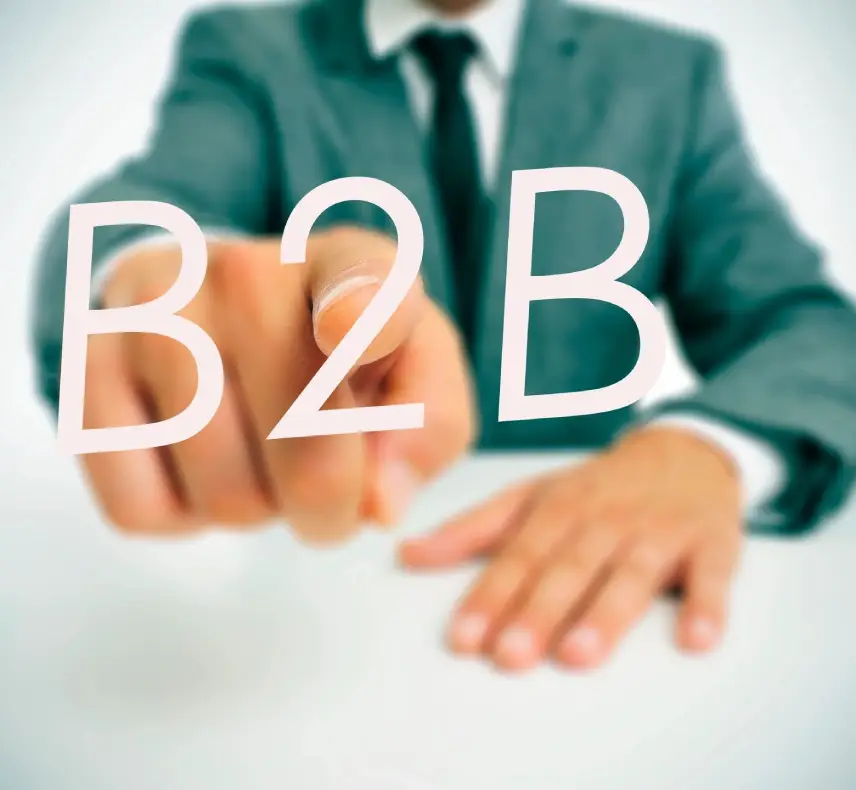 A man pointing to the word b 2 b written in white.